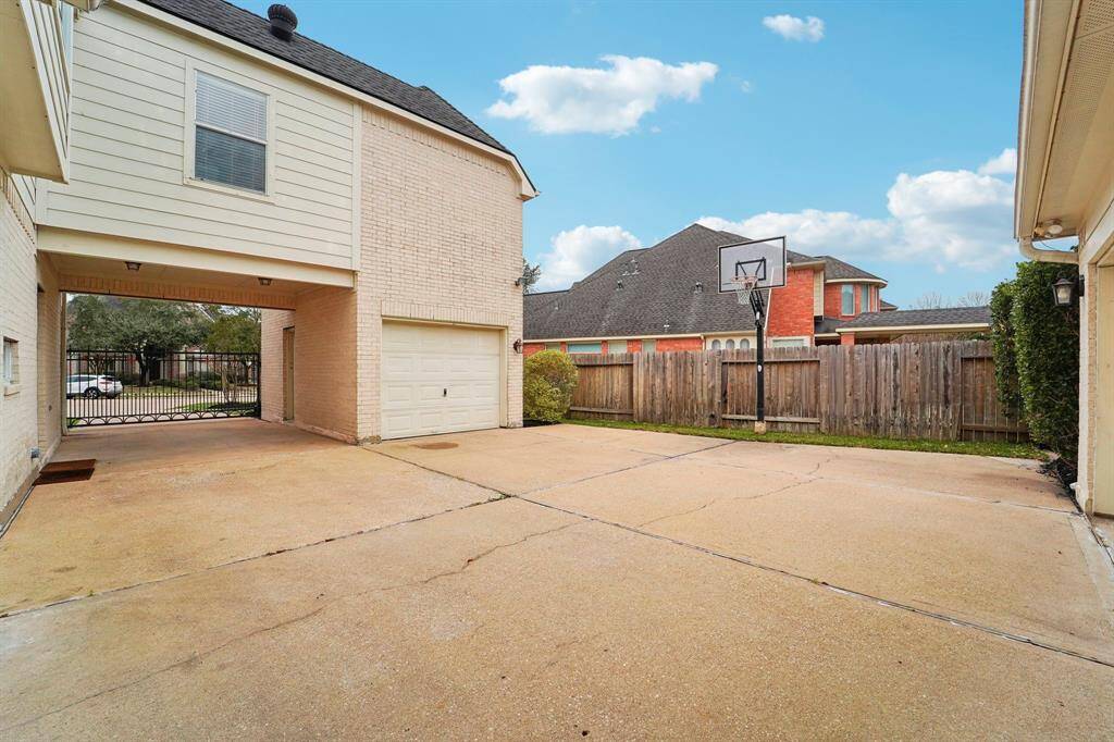 A secure, remote-gated auto court with three garage stalls provides ample parking. For added peace of mind, the home includes a built-in safe, CO2/fire alarms, and a Simply Safe alarm system, which will stay. Additionally, surge protection is installed on the HVAC units and main breakers, ensuring extra security and protection for your home’s essential systems.