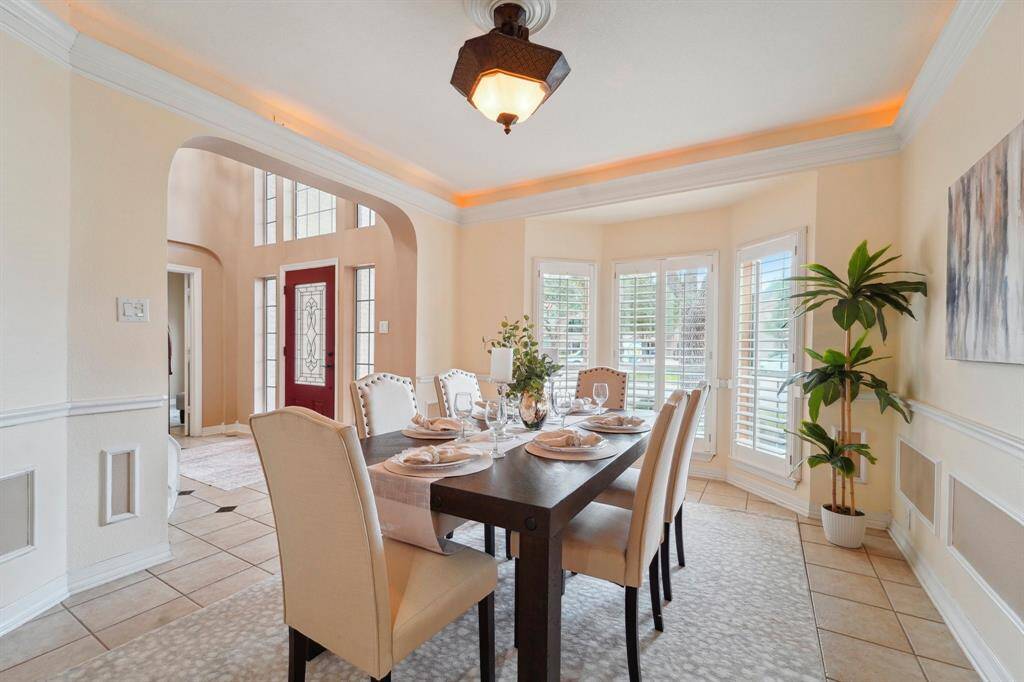 Your friends and family are going to love breaking bread with you in this elegant formal dining room with designer paint, chic lighting, and ample space for your banquet table and sideboard.