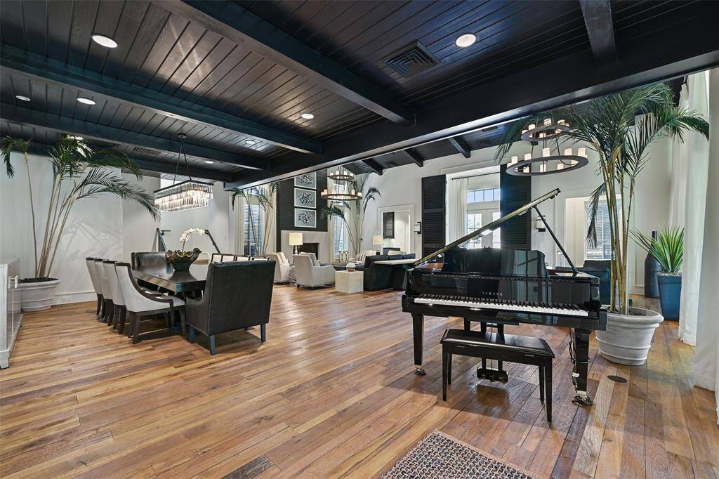Combining elegance and modern design, the great room flows seamlessly into an enchanting dining room space. Offering a beautiful floorplan to host large gatherings or intimate dinner parties. The dramatic wood ceilings create a sense of depth and casts a luxe environment.