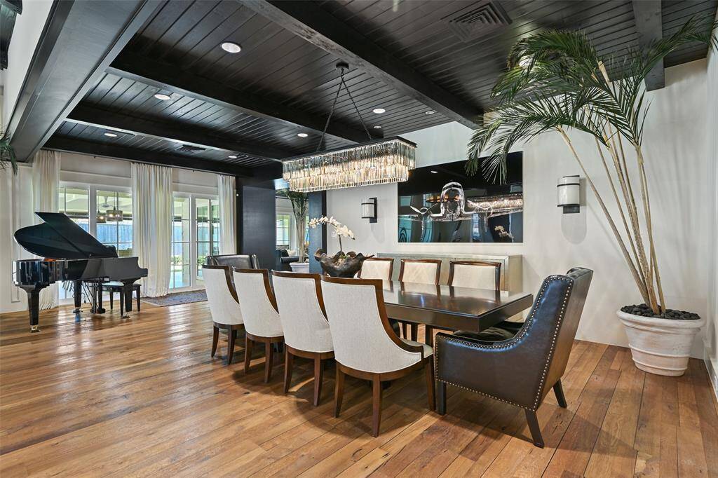 The dining room offers a perfect setting for intimate dinners and grand gatherings alike. The dining room feature wall is adorned with white solid limestone that was hand matched for the space.