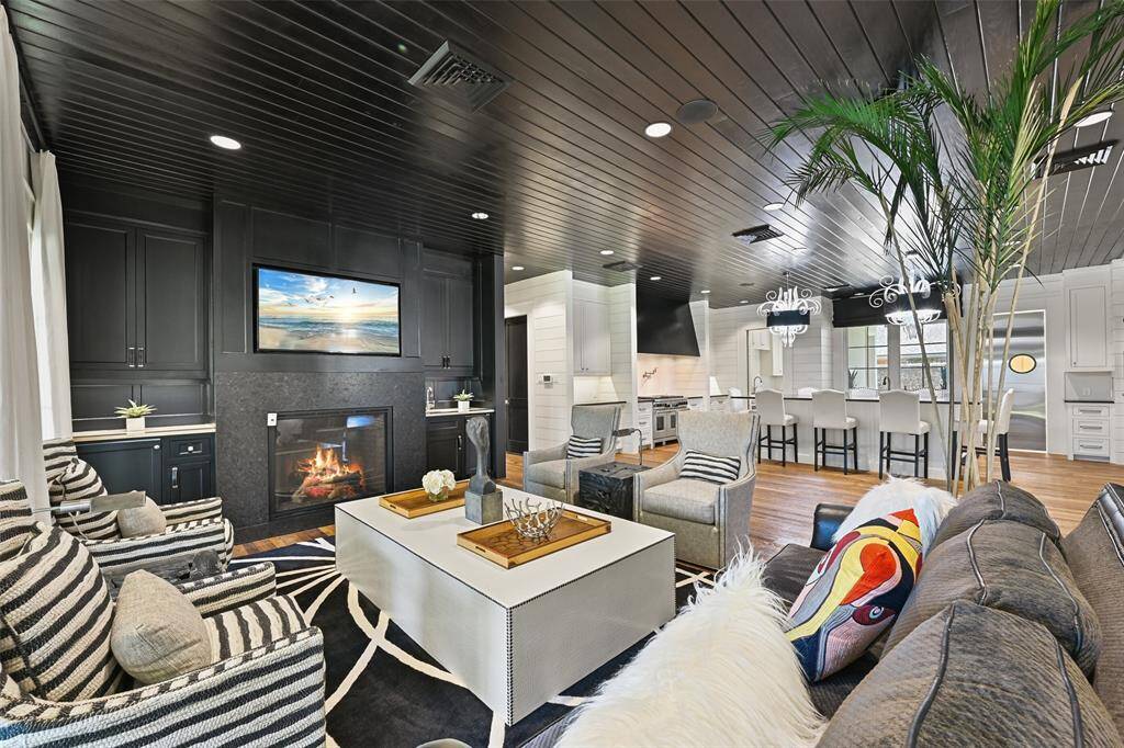 Stunning interior selections and finishes, the family room showcases a convenient wet bar with Hoshizaki ice machine & built-in beverage refrigerator on either side of the fireplace.
