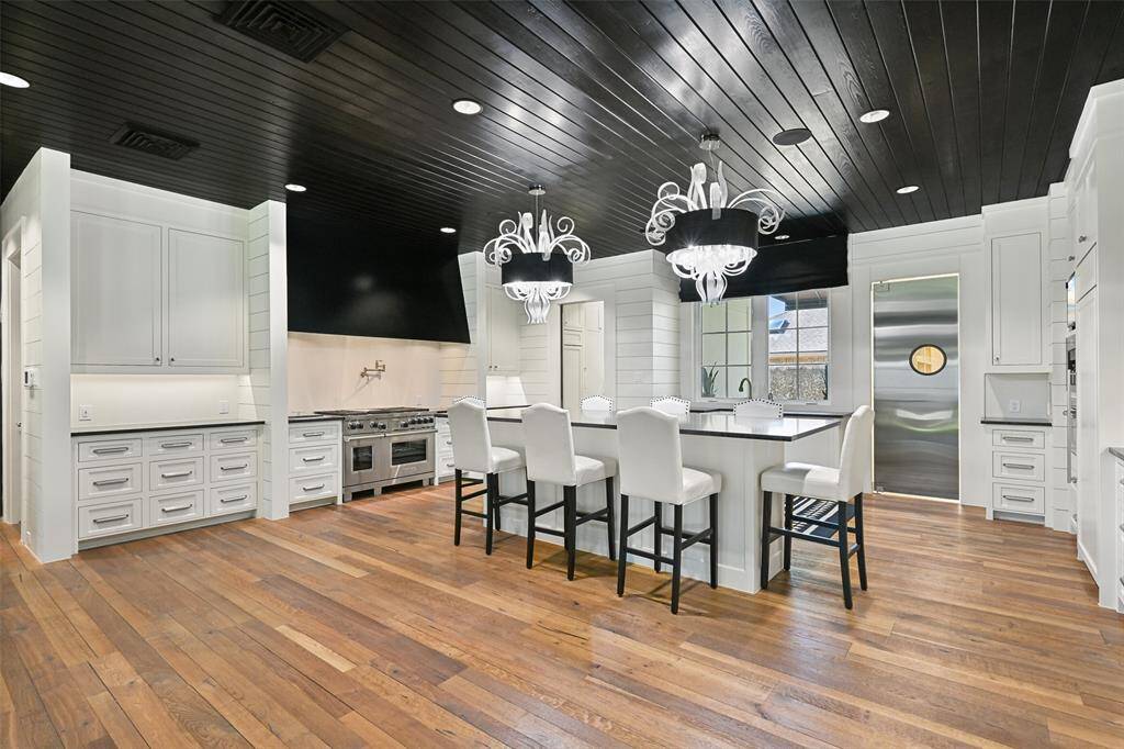 The impeccable Chef's kitchen features top-of-the-line appliances, such as built-in Sub Zero refrigerator/freezer, Wolfe range, steamer, microwave & warming drawer, built-in Miele coffee maker, Sub Zero beverage refrigerator and Miele dishwasher.