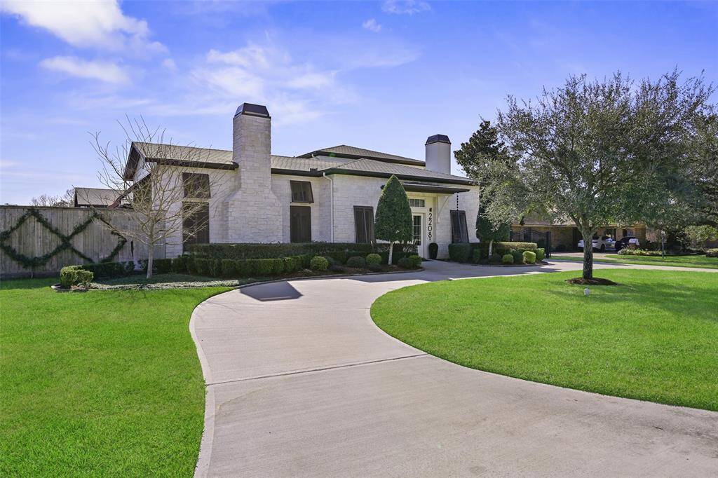 An exquisite limestone and stucco exterior are enhanced by manicured landscape design. The circular drive provides convenience and ample parking for the homeowner and guests.