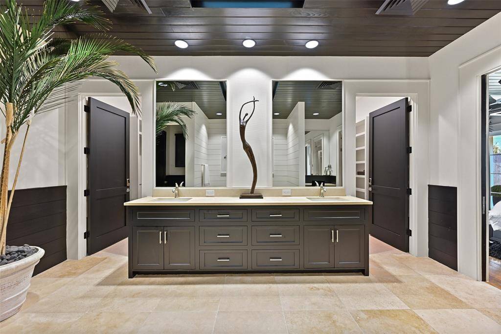 The custom dual vanity is topped with sleek granite counters complimented by striking hardware, lighting and mirrors. Two walk-in closets with an abundance of built-ins and security keypads to ensure personal items are secured.