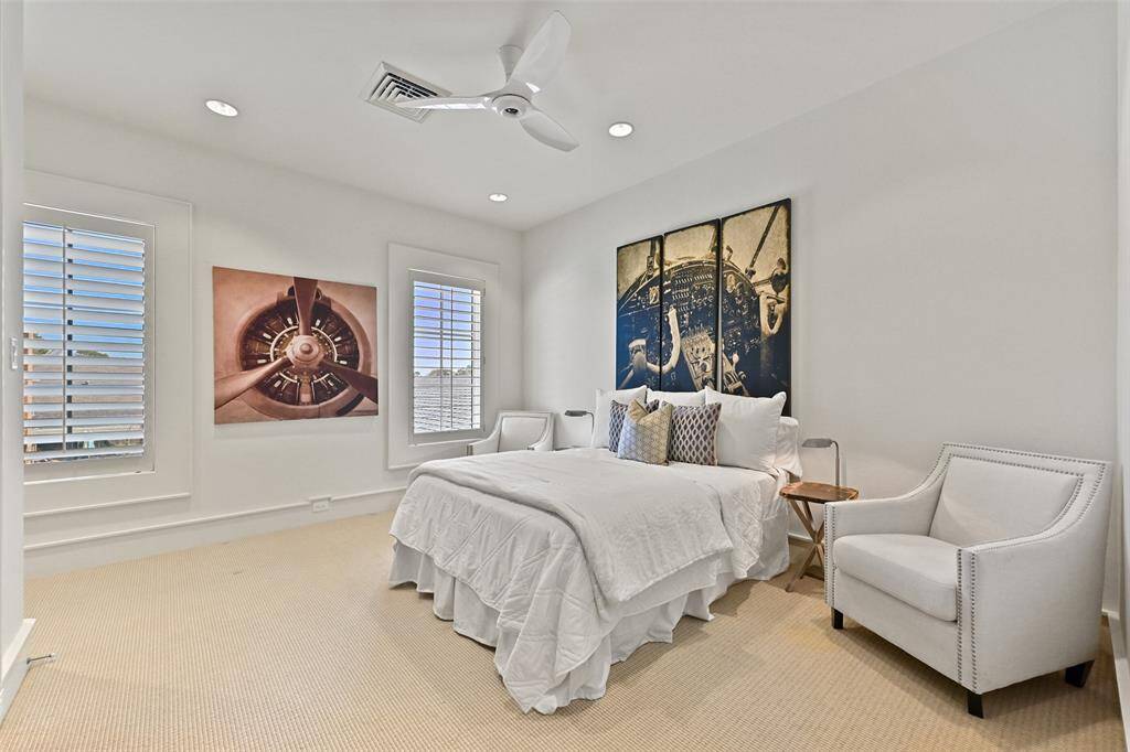 Bedroom 2 offers a serene retreat with large, beautifully cased-in windows, high ceilings, large walk-in closet, and private ensuite bathroom.
