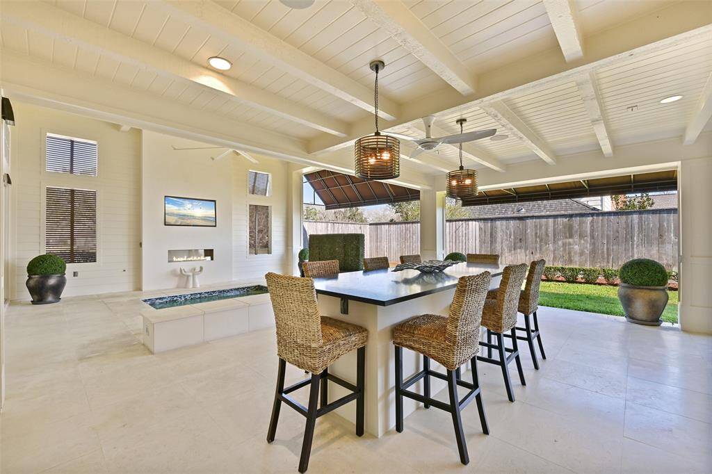 The covered patio area total approximately 1400 sq ft perfect for al fresco dining and entertaining. Featuring elegant stone hardscapes, this space combines luxury and functionality.
