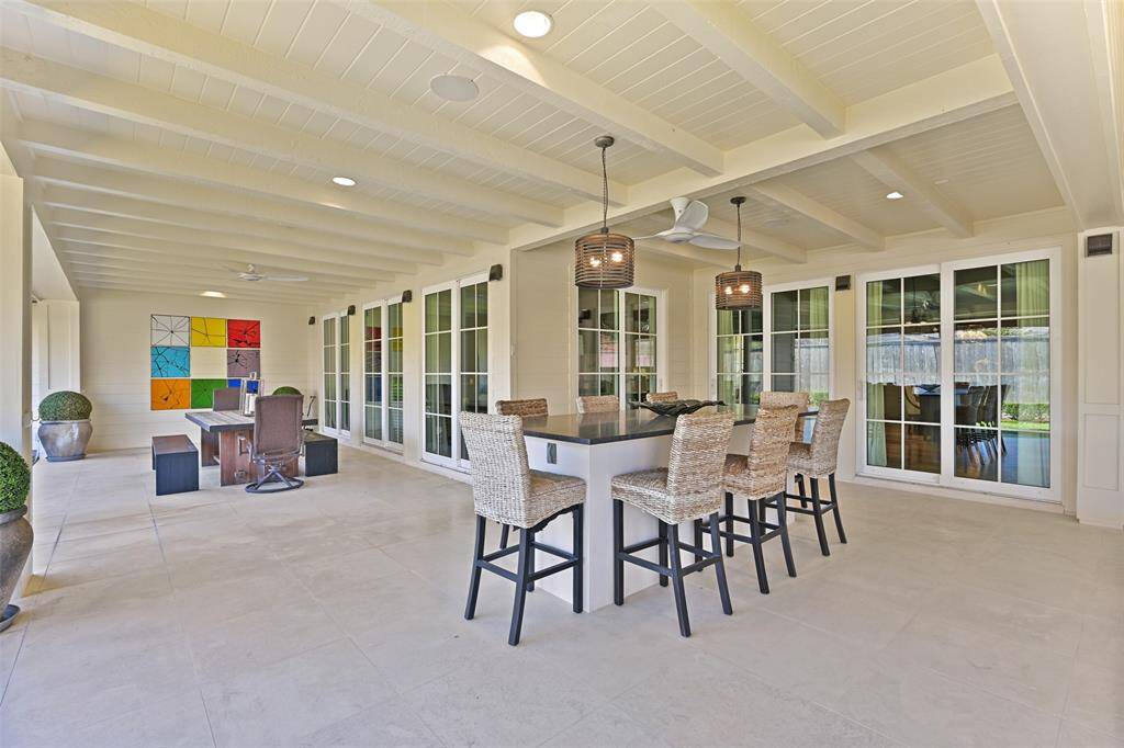 Additional patio space provides a perfect setting for outdoor dining easily acccessible from multiple locations within the interior living spaces. Layered lighting, sound system, bug mist system and numerous outdoor fans ensure comfort and continued outdoor enjoyment.