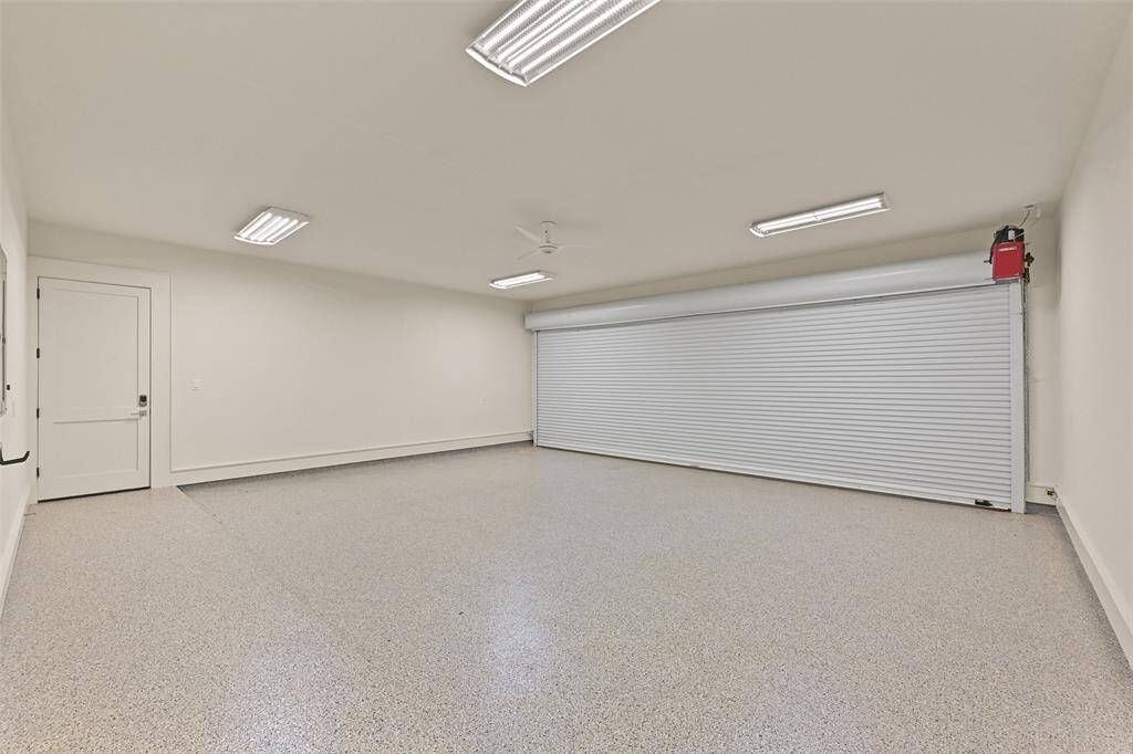 The expansive 700 sq ft garage features a wide 25ft commercial overhead door with epoxy floors & door leading directly into the airplane hangar from the garage and house.