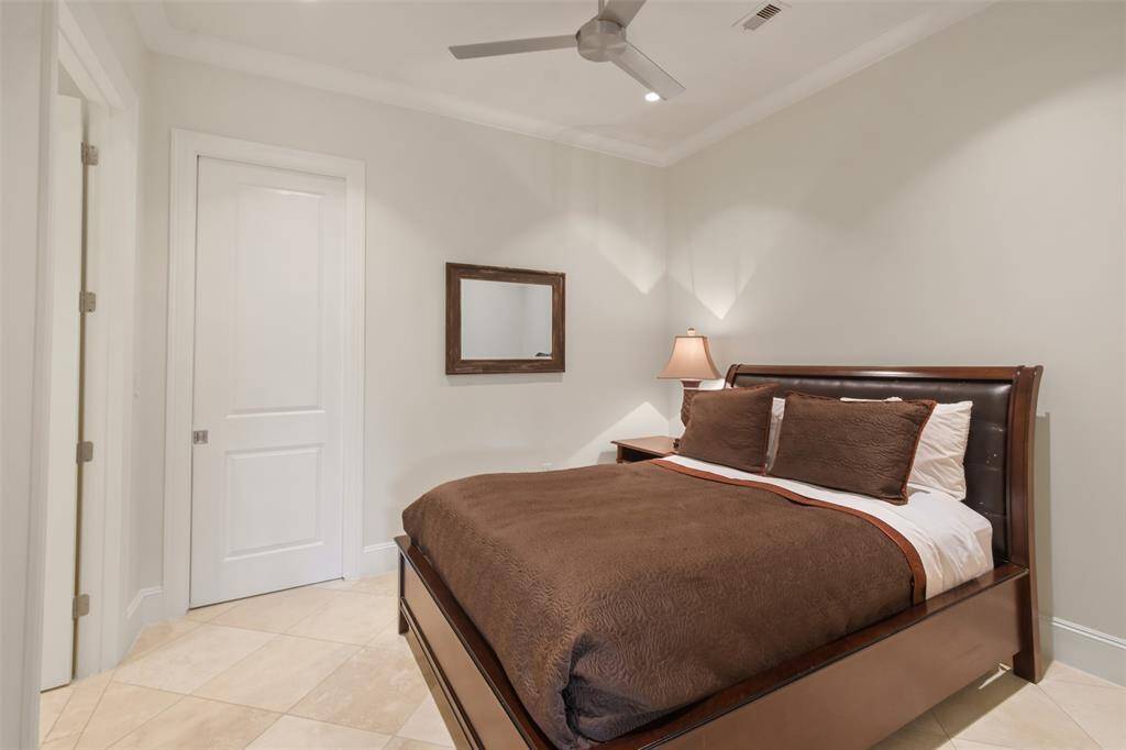 Secondary bedroom number two has a large walk-in closet with custom built-ins as well as it's own private bath.