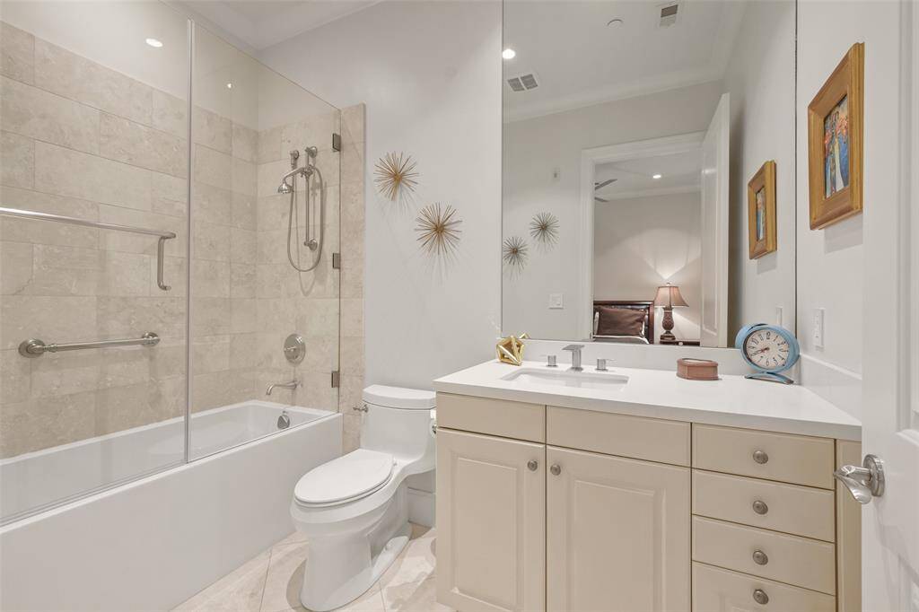 The bath in the second bedroom features a deep tub shower combination with hand held shower head.