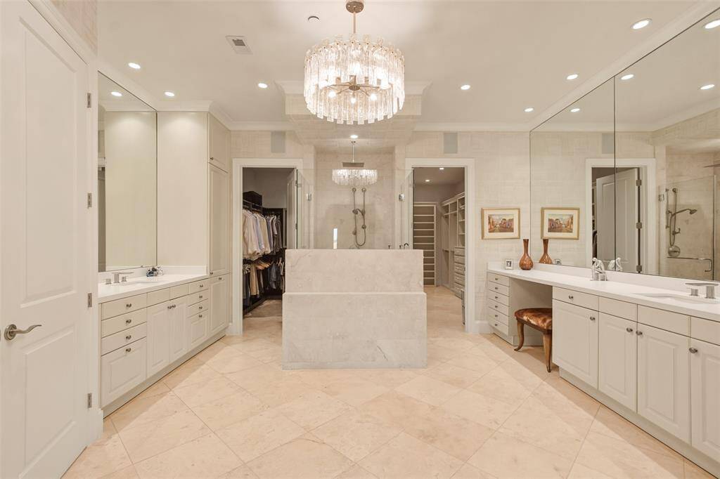 The lavish primary bath features dual vanities, double frameless glass doors lead to the oversized shower, two large walk-in closets and private lavatory.