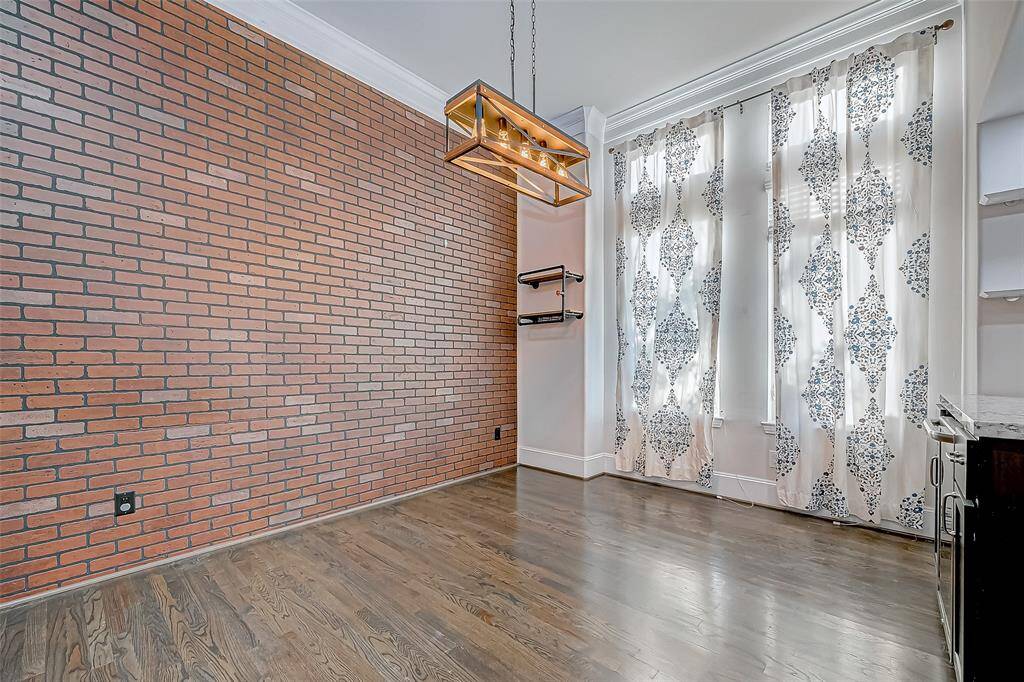 Striking Brick Accent Wall Within Dinning Room