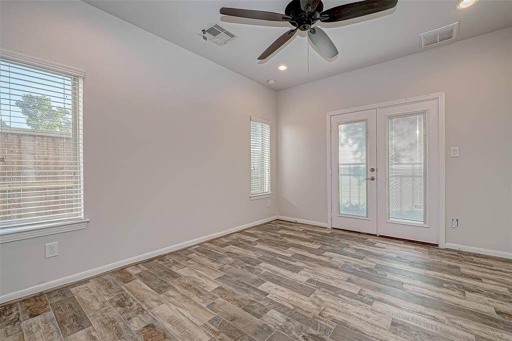 1st Floor Bedroom w/ Patio/Backyard Access. Perfect for Office! Tile Flooring!