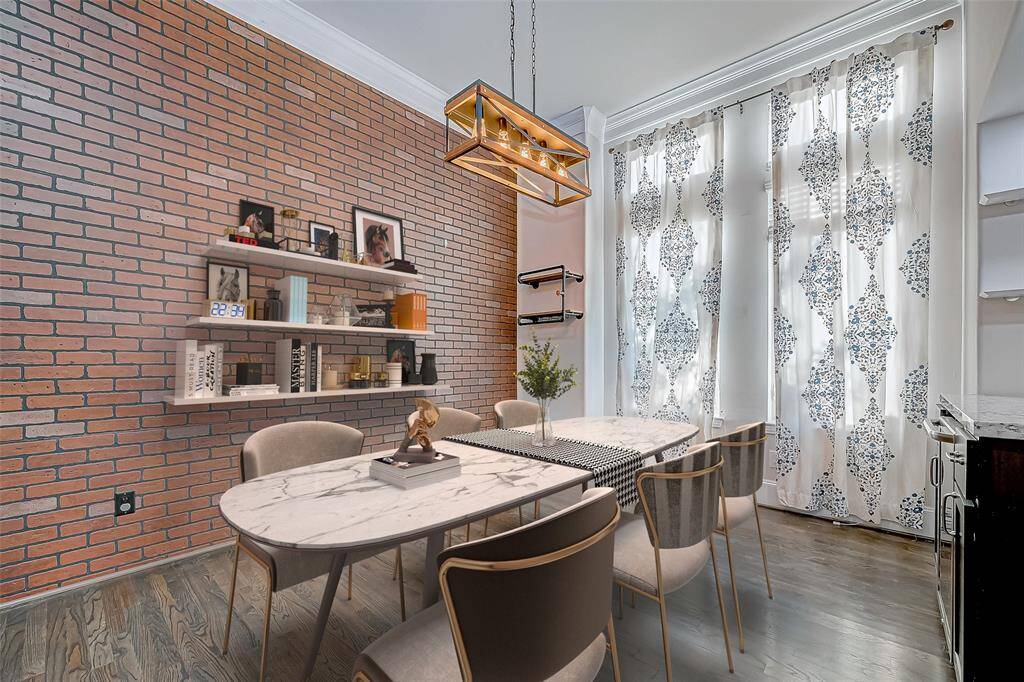 Striking Brick Accent Wall Within Dinning Room. Virtually Staged