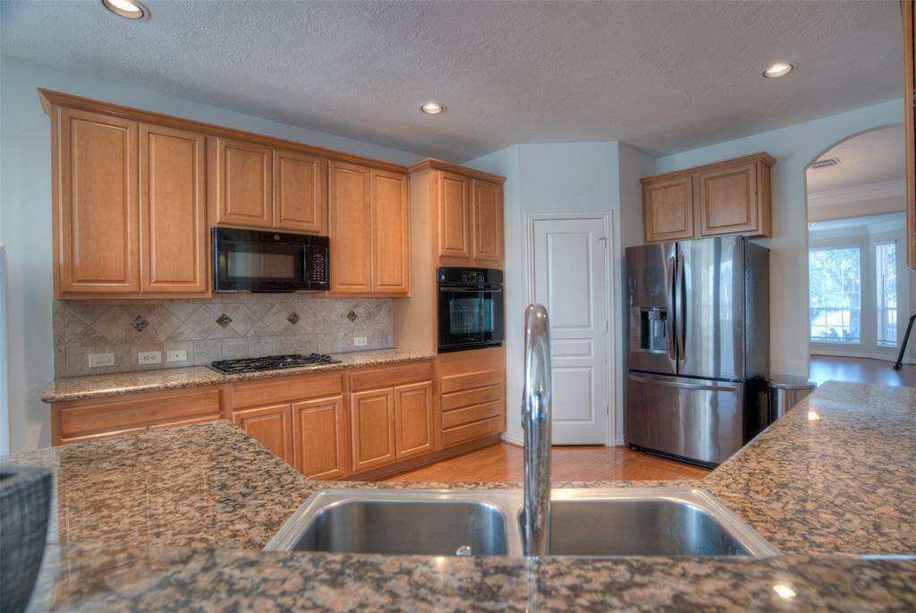 Open kitchen which allows for view of beautiful lake in the backyard.
