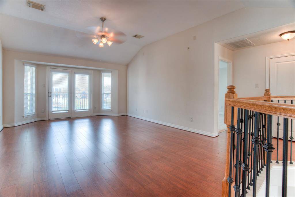 So much space in the upstairs gameroom, which leads to the backyard balcony.