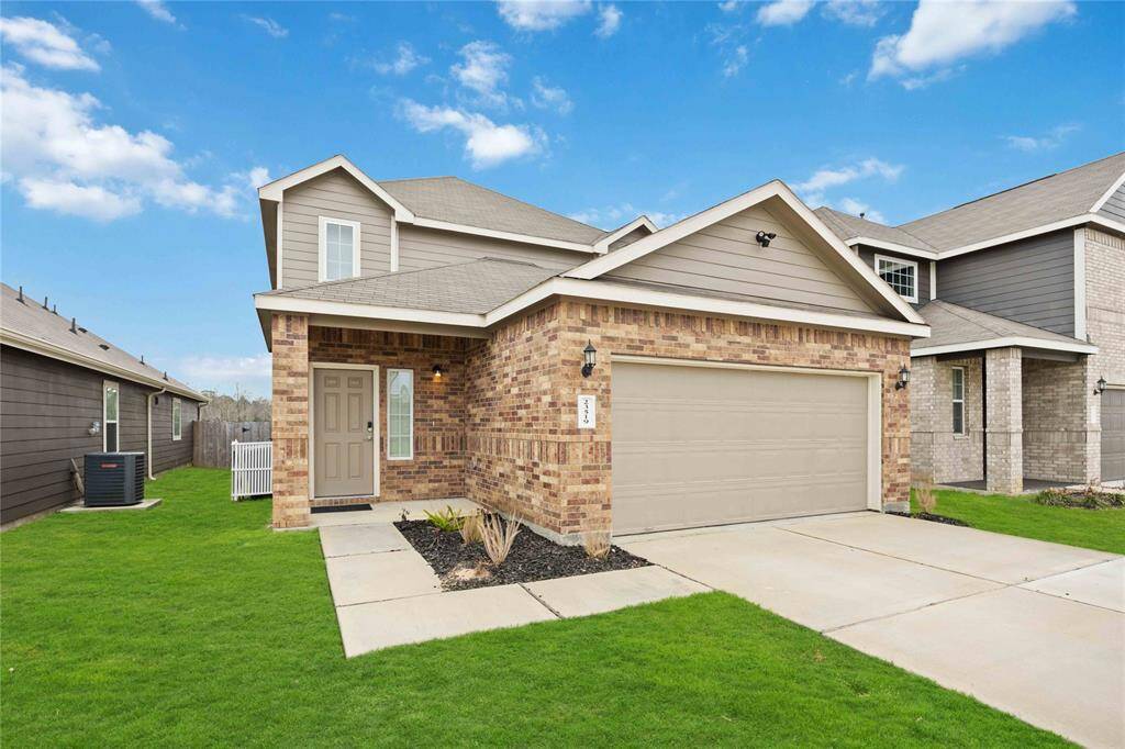 Charming brick-front home with a spacious two-car garage nestled in a friendly neighborhood. A perfect blend of style and comfort.