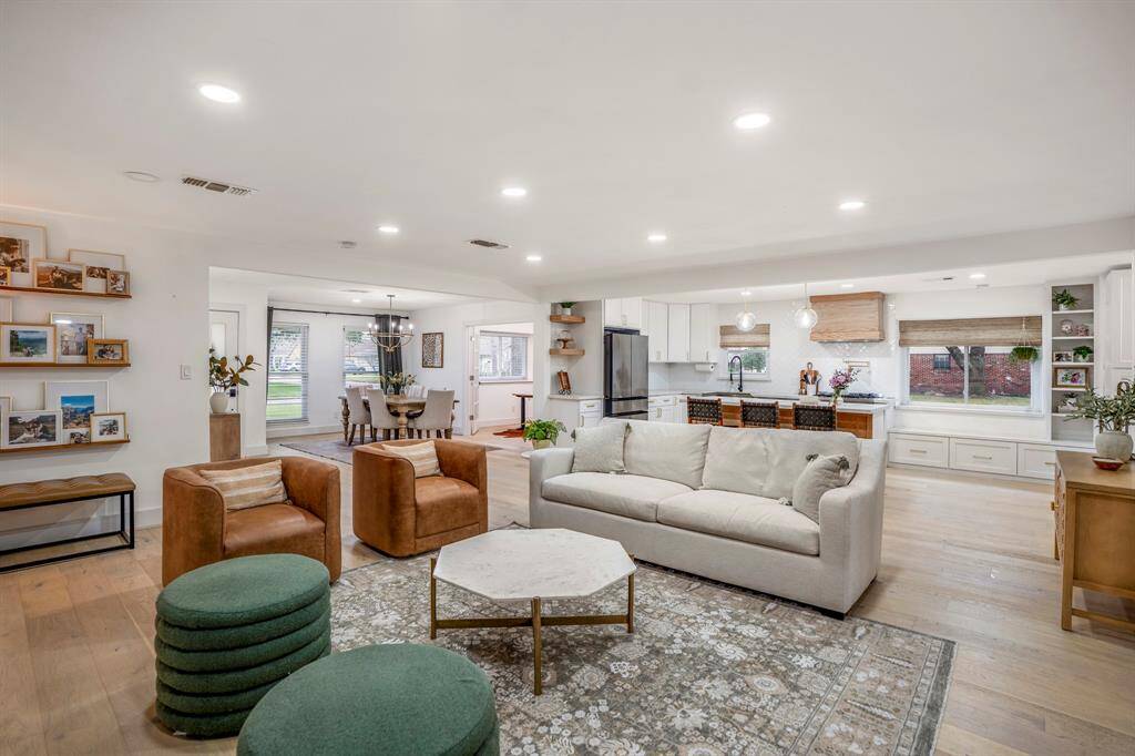 Whether it's a simple night in or entertaining family and friends, this home has ample open space for everyone to enjoy! Featuring recessed lighting, an open layout, and luxurious wood floors this living space offers it all.