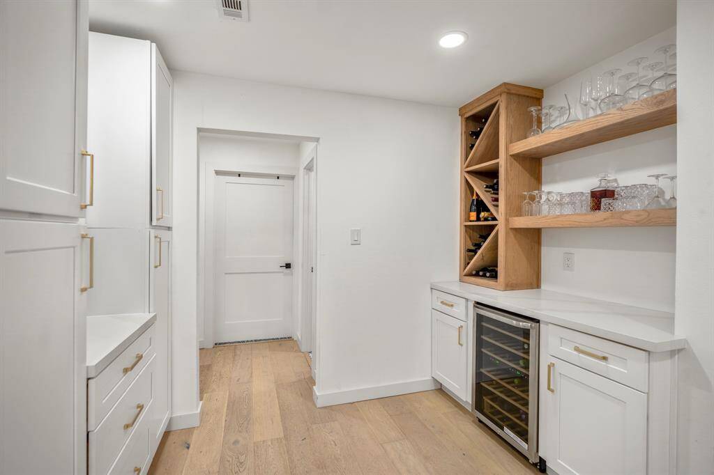 This charming coffee nook & wine space is the perfect blend of function and style, featuring built-in storage, a sleek wine fridge, and plenty of room for your favorite bottles & brews. Whether you're starting your day with coffee or winding down with a glass of wine, this space has you covered!