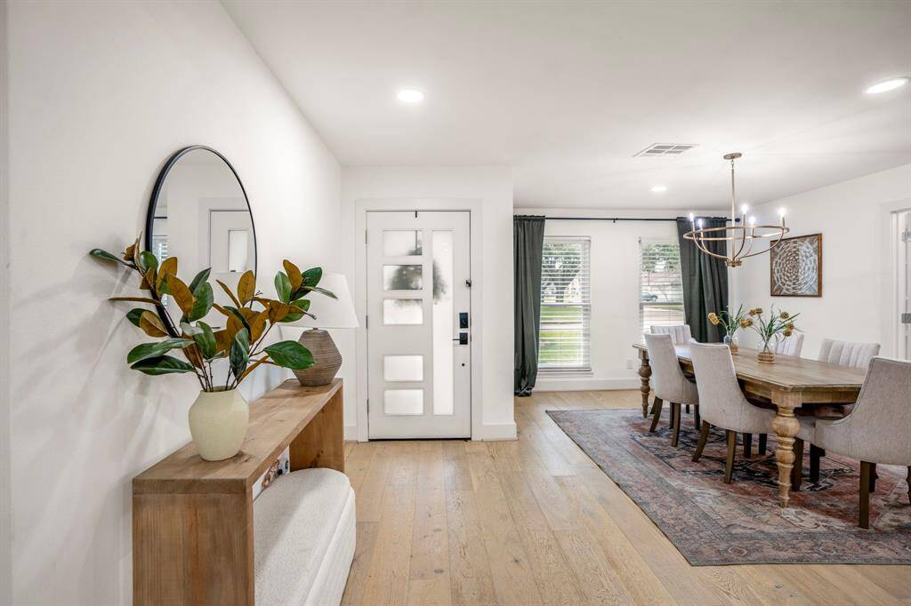 Heading back to the front of the home, you see another view of the open entry way leadinging to the dining area and home office.