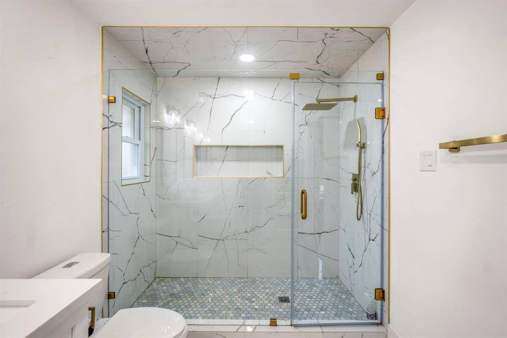 Step into pure luxury with this expansive walk-in shower, designed for both style and function. Featuring a sleek frameless glass surround, stunning marbled tile, and a durable mud-set floor for a spa-like feel. Natural light pours in, creating a bright and airy atmosphere—transforming your daily routine into a rejuvenating escape.