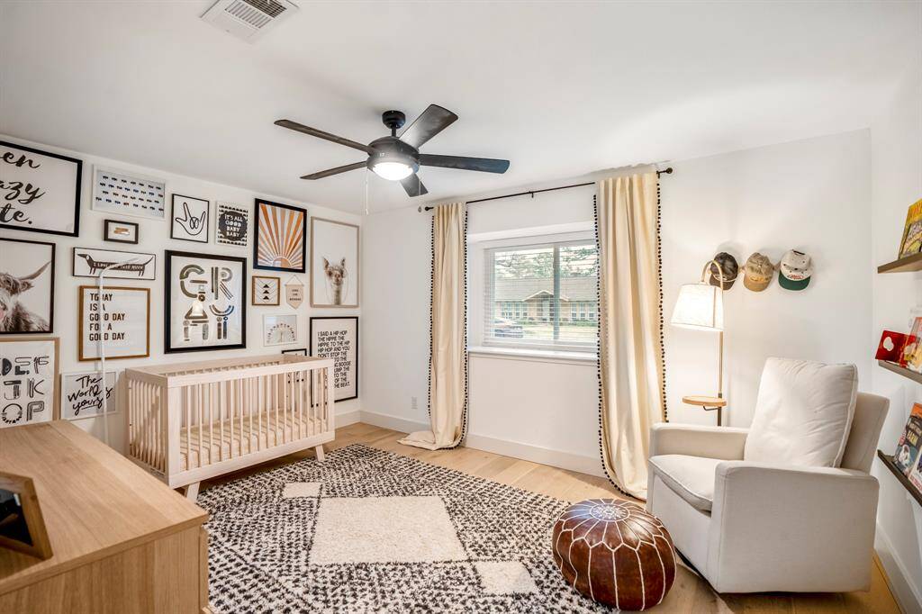 Bright, airy, and effortlessly inviting! This secondary bedroom features warm wood floors, ample natural light, and a stylish ceiling fan for year-round comfort.