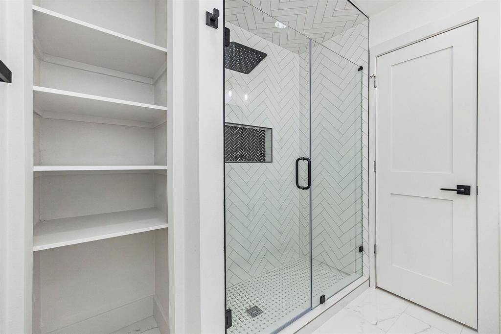 The last bathroom is complete with a spacious walk-in shower completed with modern tile, mud-set flooring, and a rain showerhead!