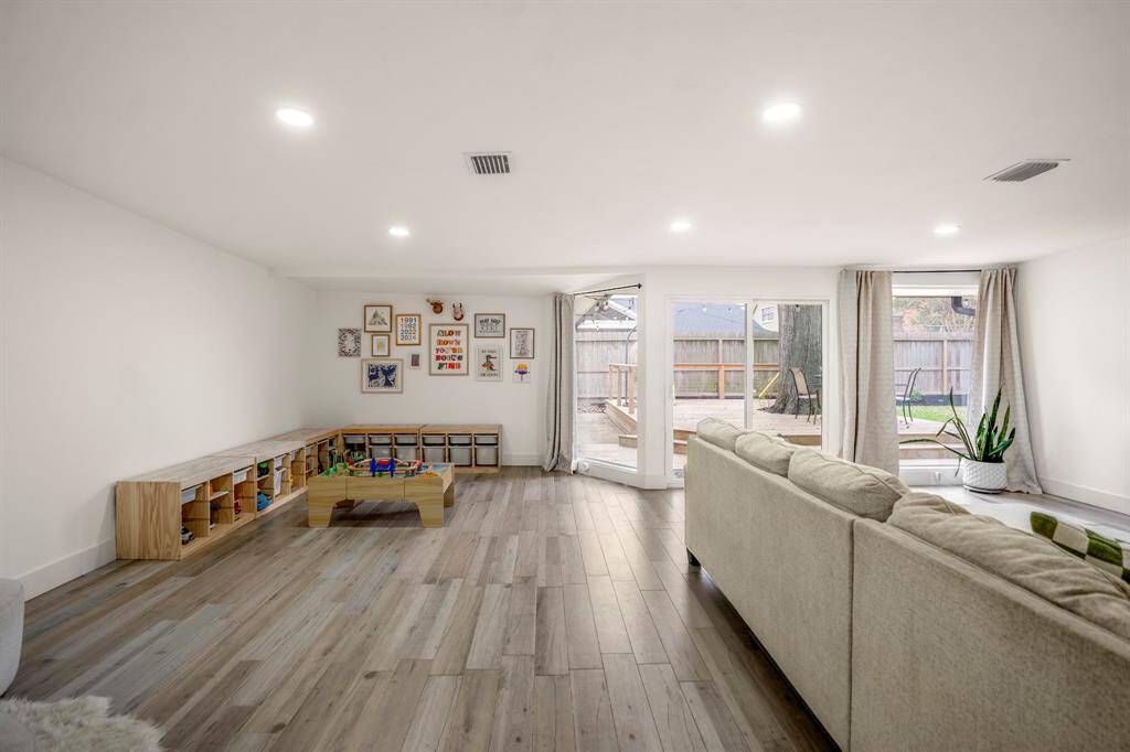 Endless possibilities await in this spacious bonus room! With expansive windows overlooking the backyard and sleek sliding glass doors for seamless indoor-outdoor living, this versatile space is ready to transform. Whether you envision a game room with a pool table, a private home gym, a cozy library, or something entirely your own—this room adapts to fit your lifestyle.