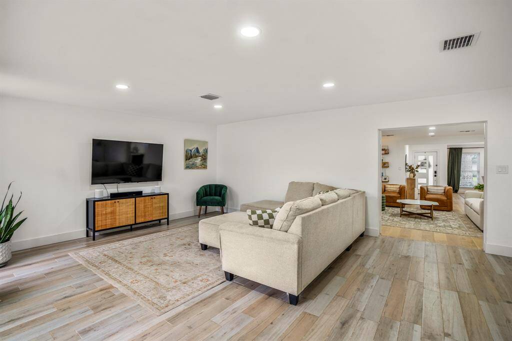 This spacious game room features wood tile flooring, recessed lighting, and is just off the kitchen and living area—perfect for movie nights, game days, or just hanging out. Let the good times begin!