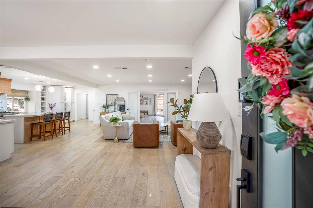 Walking in, you find a bright entryway with beautiful light oak wood flooring that continues throughout the home making it easy to maintain. The open design and natural light create a warm, welcoming atmosphere, setting the perfect tone for the rest of the home.