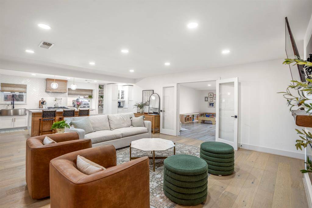 Another view shows just how open concept this kitchen and living room is. So much natural light and space! The living area connects to the bonus space or game room through timeless french doors.
