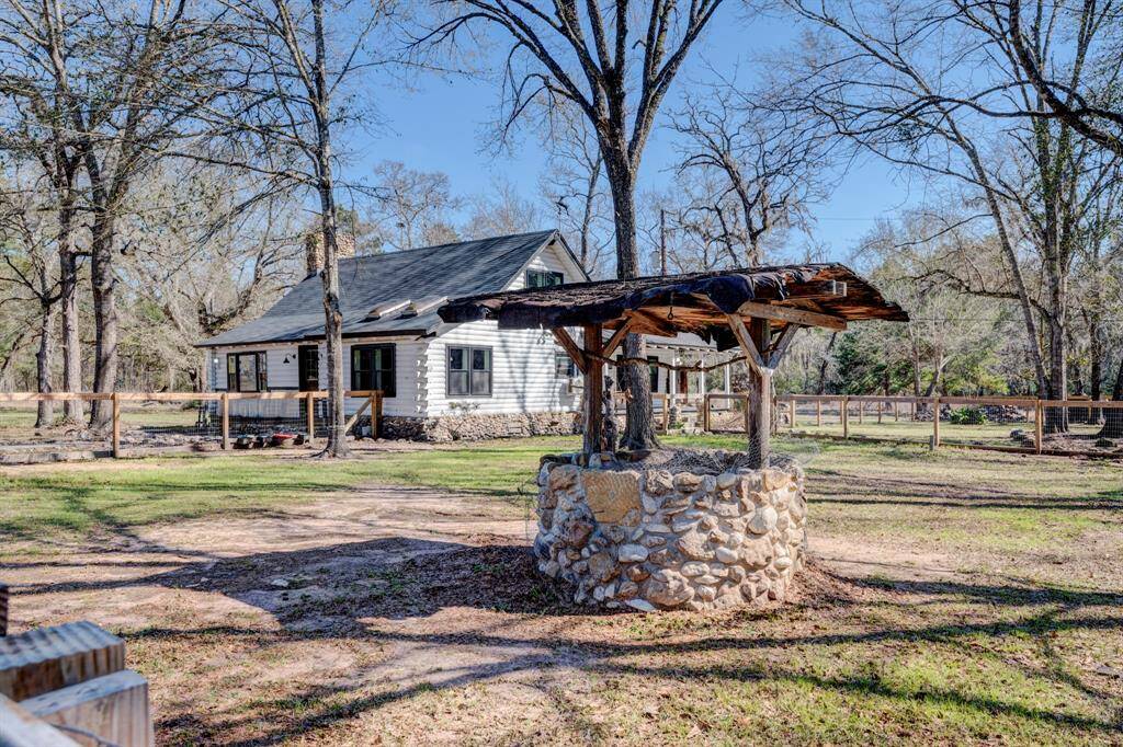 Decorative wishing well is located within the cross fenced part of the property.