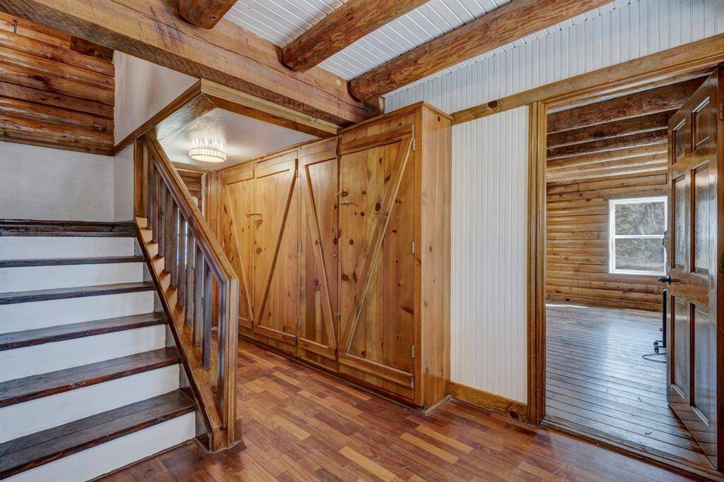 Primary bedroom is to the right of the entryway. The custom built cabinets against the wall provide storage for linens or clothes.