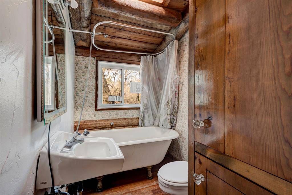 Secondary bathroom upstairs.  It is equipped with a stand alone cast iron tub that is equipped with a shower.