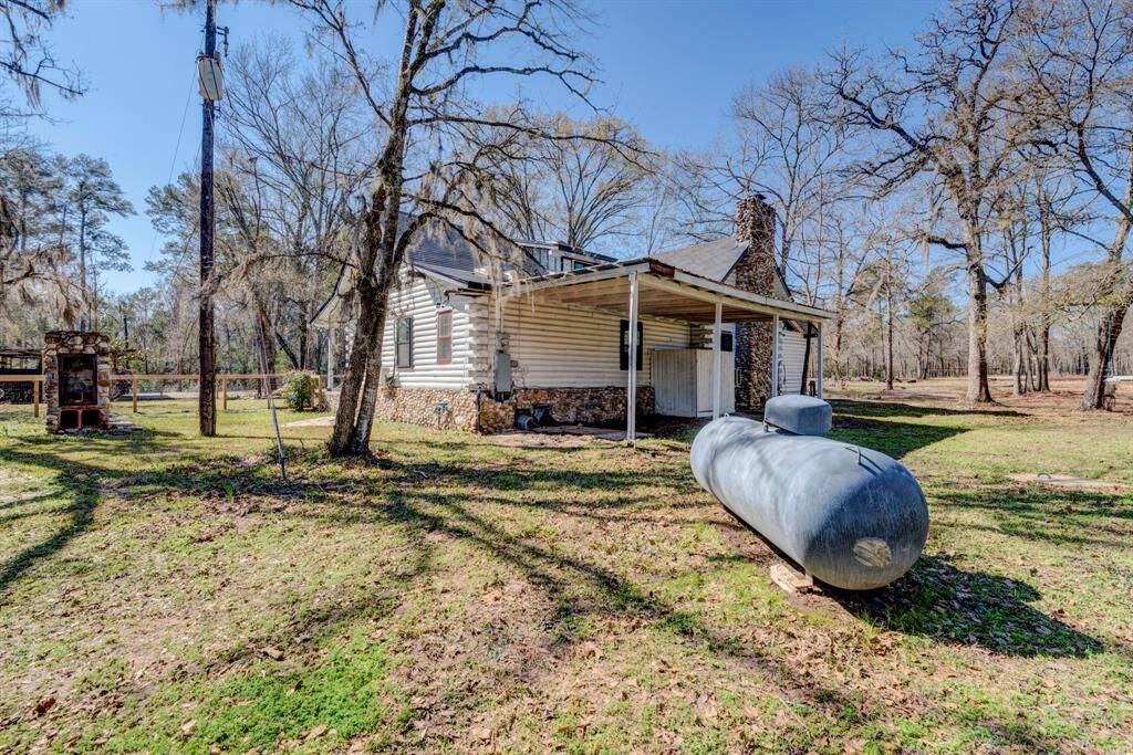Back of the home has a covered back porch area .