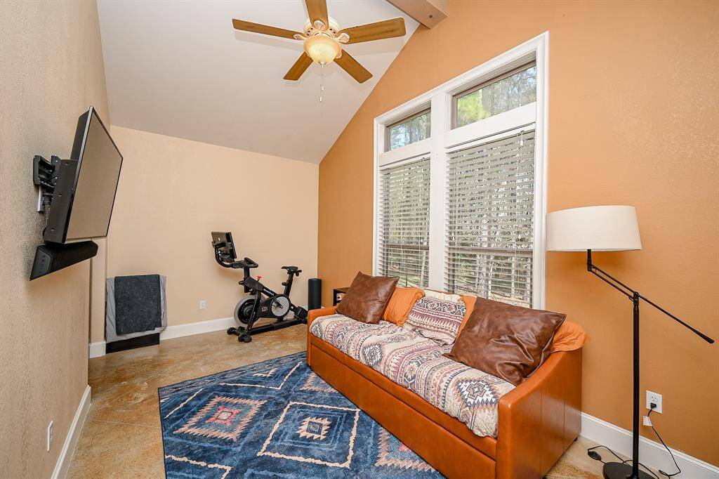 The primary bedroom of this house gives new meaning to "seating area."  Can you picture what you will do with this room that is accessed through the dual arch entryways?  The same concrete flooring and vaulted ceiling and large windows create an atmosphere for you to add whatever touch you wish.  So many options are possible!