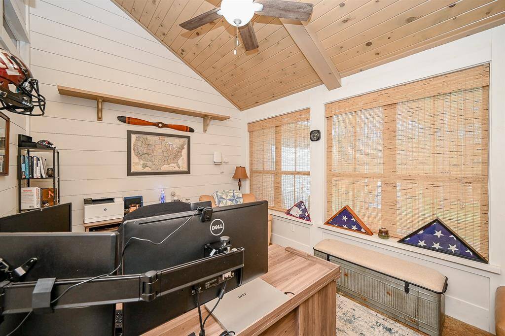Viewed from another angle, another primary feature of this room are the nearly full length windows that allow for plenty of natural light to enter.  Just on the other side of these windows is a wooden outdoor patio that runs the  entire length of the room.  The patio is accessed through a door just to the right of the photo.