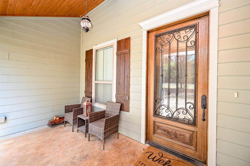 This property says "Texas" and "Welcome" throughout its design. A large covered patio with designer wood ceiling, painted concrete flooring and a designer front door with accents invites you in to see all the other great things about this home.
