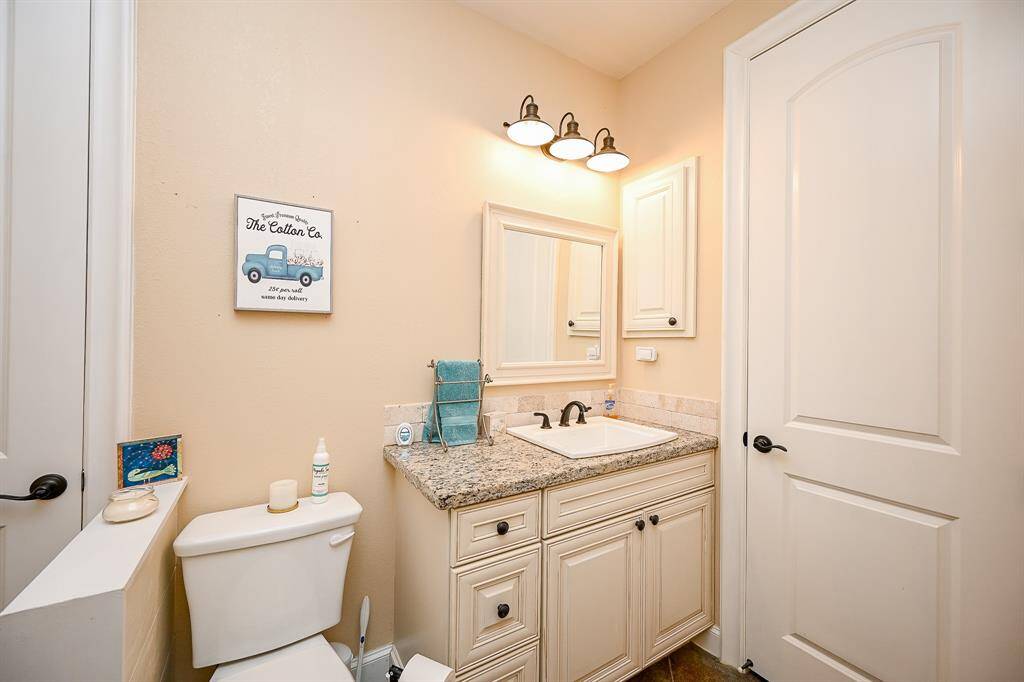 The second living area features a separate bathroom complete with single sink, granite counter top, designer lighting and plenty of cabinet space.  This bathroom features a walk-in shower with full height backsplash.