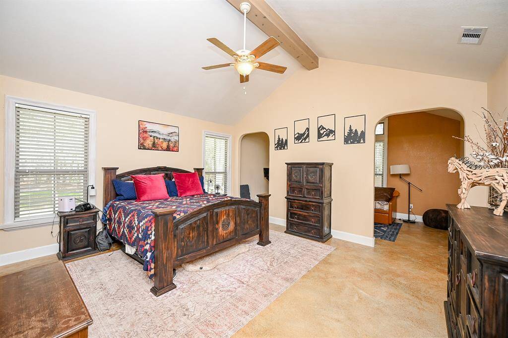 The primary bedroom has "big as Texas" as its motto!  A pair of large windows complete with plantation-style blinds allows for ample natural light to pour into the room.  Room features the painted concrete flooring, vaulted ceiling, ceiling fan, smoke detector and still leaves room for you to add so much to fit your needs.