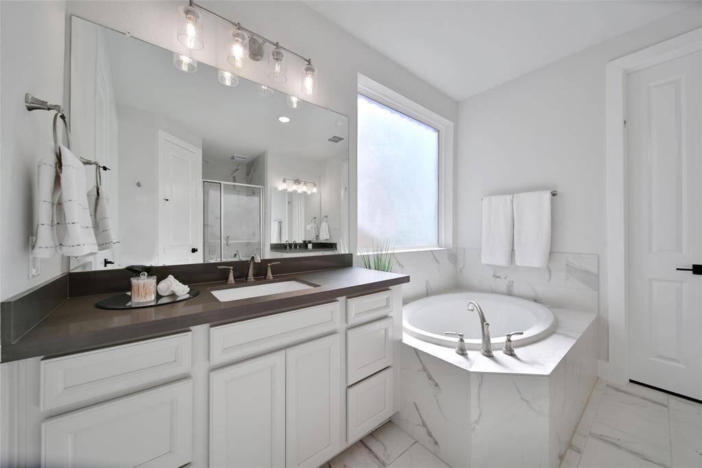 Dual vanities with quartz counter tops offer plenty of space for two to get ready each day.