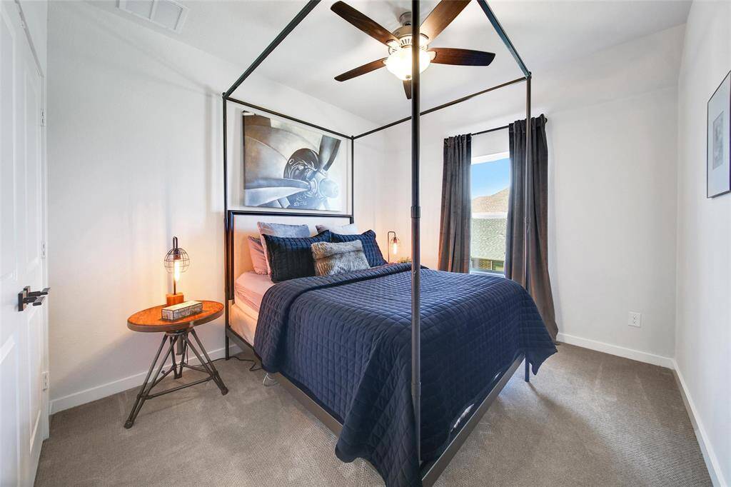 One of Two upstairs bedrooms -  includes a Ceiling Fan.