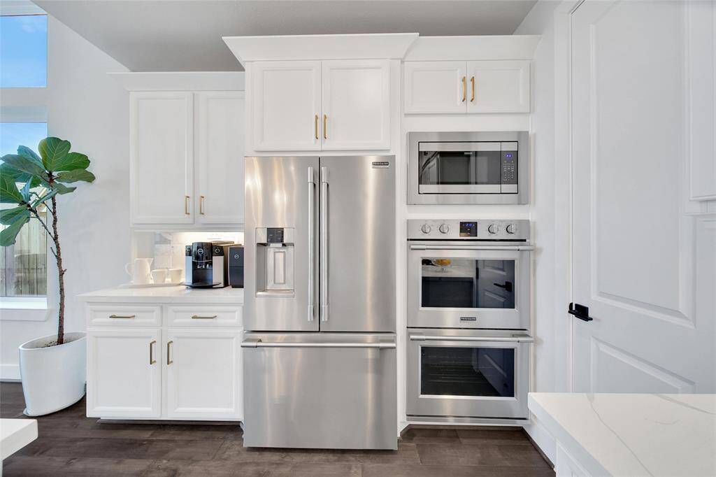 Upgraded Frigidaire Appliances include double ovens, microwave, 36" gas cooktop with 42"arch vent hood plus dishwasher. BONUS: Counter Depth French door refrigerator could stay!