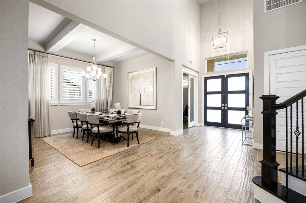 Private study with double glass doors is located at the front of the home. Formal dining space has plenty of room for your large pieces and is complimented by beams on the ceiling. Add your favorite lighting and create your own experience for your guests.