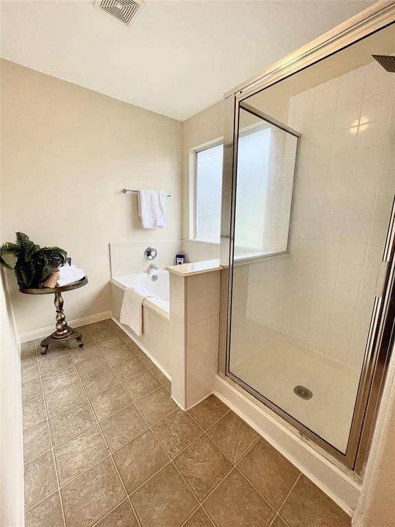 Primary bath has a separate tub and shower.