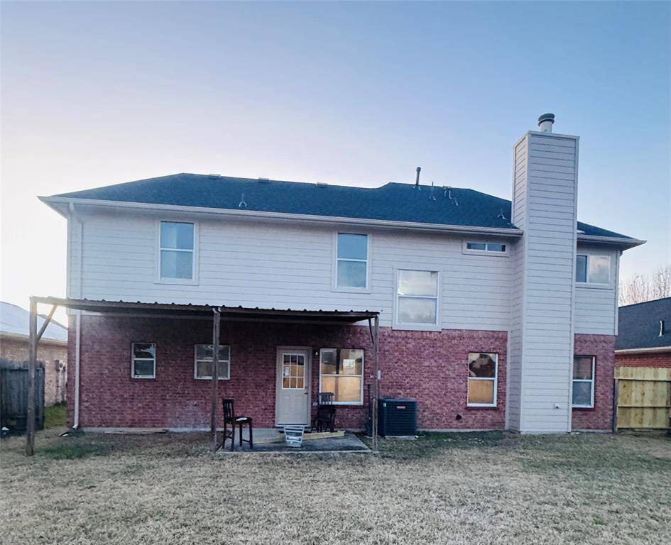 Relax on the back porch and enjoy the expansive yard.
