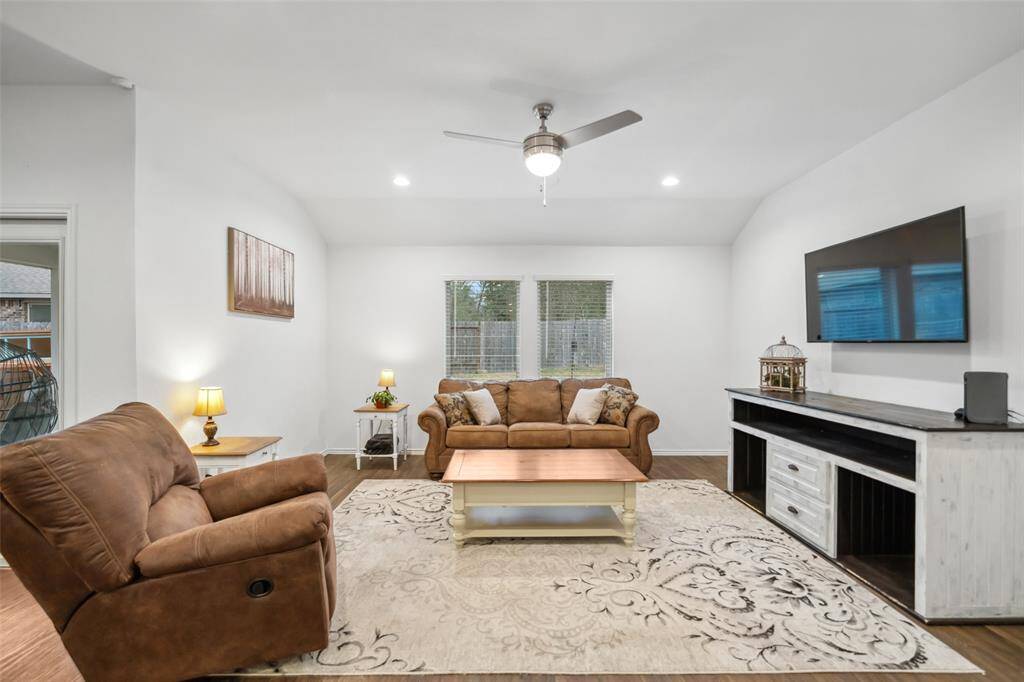 Family room features comfortable seating and wall mounted TV.