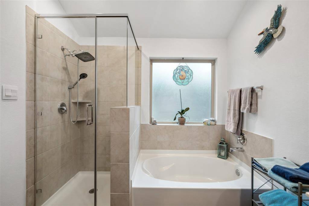 Primary suite features large soaking tub with separate shower, double vanity sink and large walkin closet. Comes furnished with towels and linens.