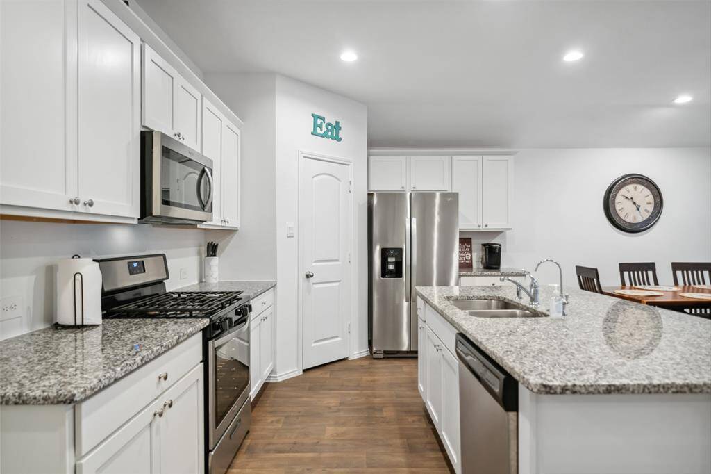 Kitchen features SS appliances, granite countertops & large walk in pantry.