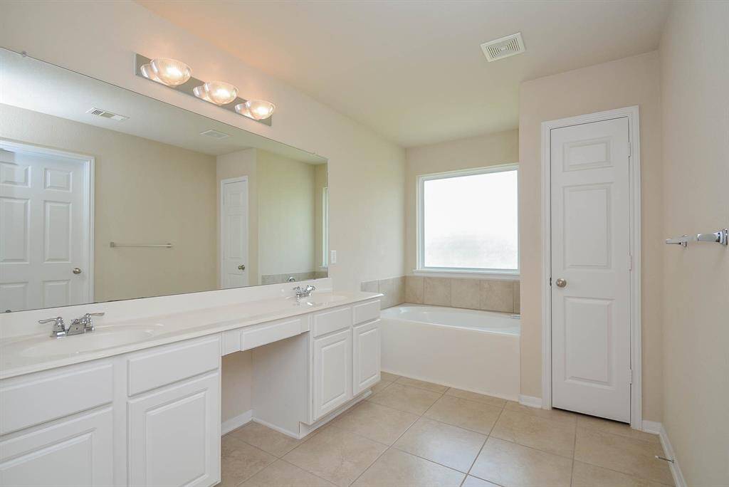 The master bathroom includes double sinks with garden tub and separate shower.